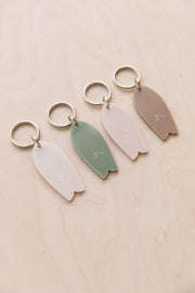 Surf keychain with wave pattern in neutral tones